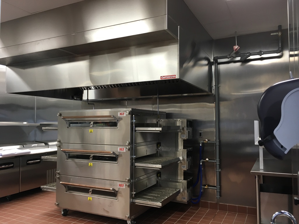 Completed commercial restaurant kitchen with hood system